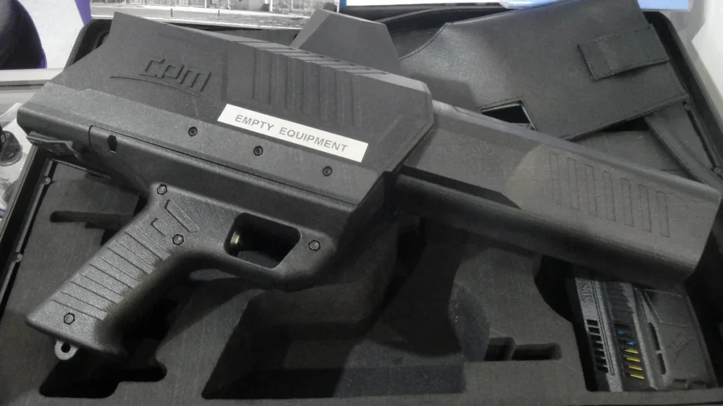 A handheld anti-drone jammer on display at a trade show
