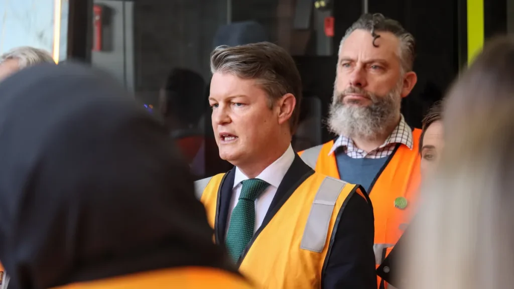 Ben Carroll, Premier of Victoria, speaking at a press conference in a high visibility vest